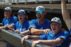 Baseball players in blue uniforms with decorated Richardson 212 Pro Twill Snapback Caps and cheering from the dugout.