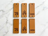 Set of six leather tags with engraved designs and pre cut rivet and sew holes to support DIY attachment.